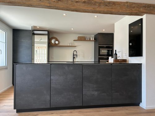 Elegante schwarze Designküche mit Kochinsel und modernen Einbaugeräten